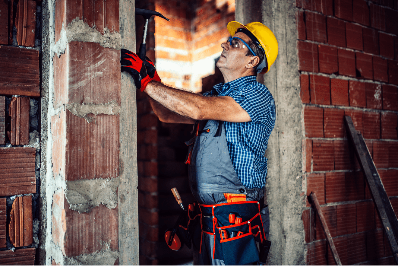 man repairing a brick wall